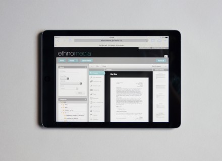 Photograph of iPad on a grey background showing the ethnomedia website on its screen.