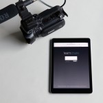 Photography of a Canon XA10 camcorder alongside an iPad with the Team Share login on its screen.