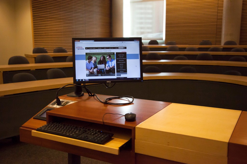 Photograph of a typical podium with a computer monitor displaying the guelphhumber.ca website.