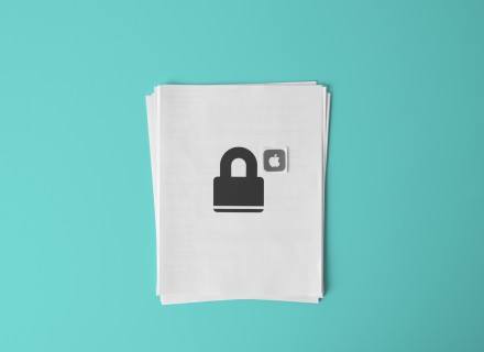 Photo of white printer paper with an image of a lock and an apple computers icon on the page.