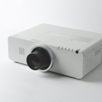 Photo of a projector sitting on a white surface