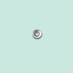 Photo of a round power button sitting on a turquoise background.